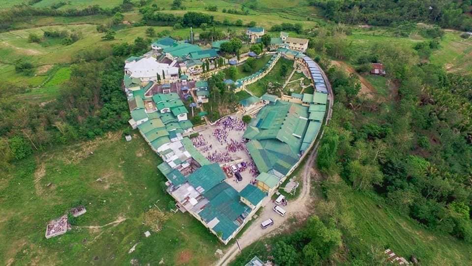 Aerial view of the heart-shaped Peniel compound nestled in green hills